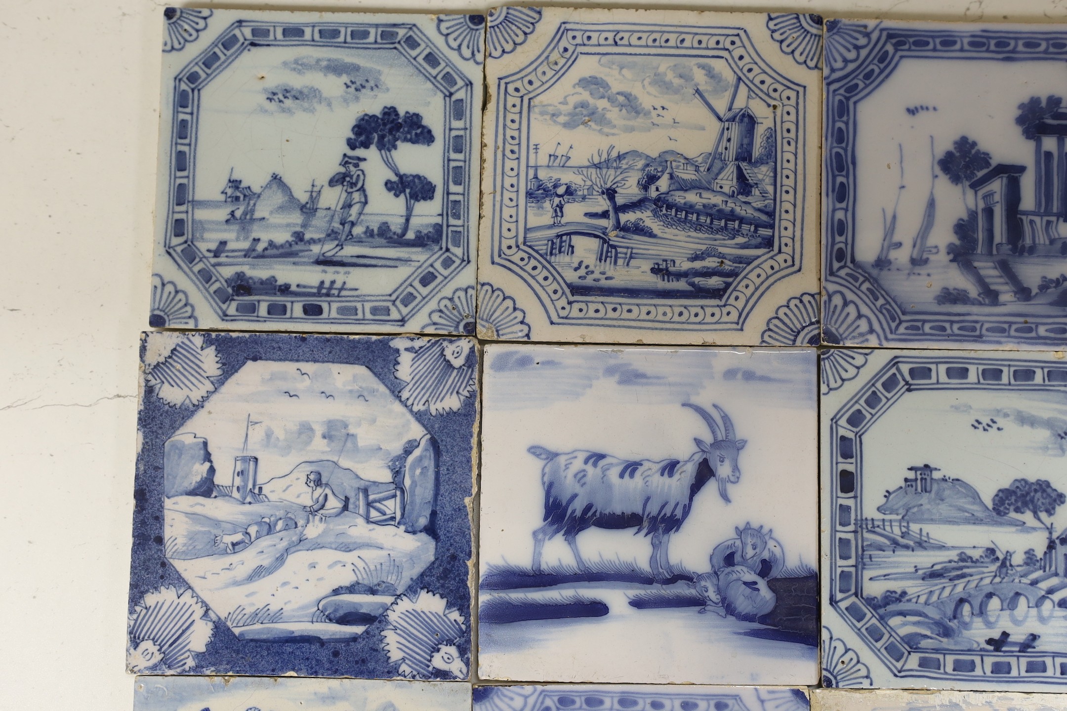 Nine various Delft blue and white landscape or animal tiles, 18th/19th century